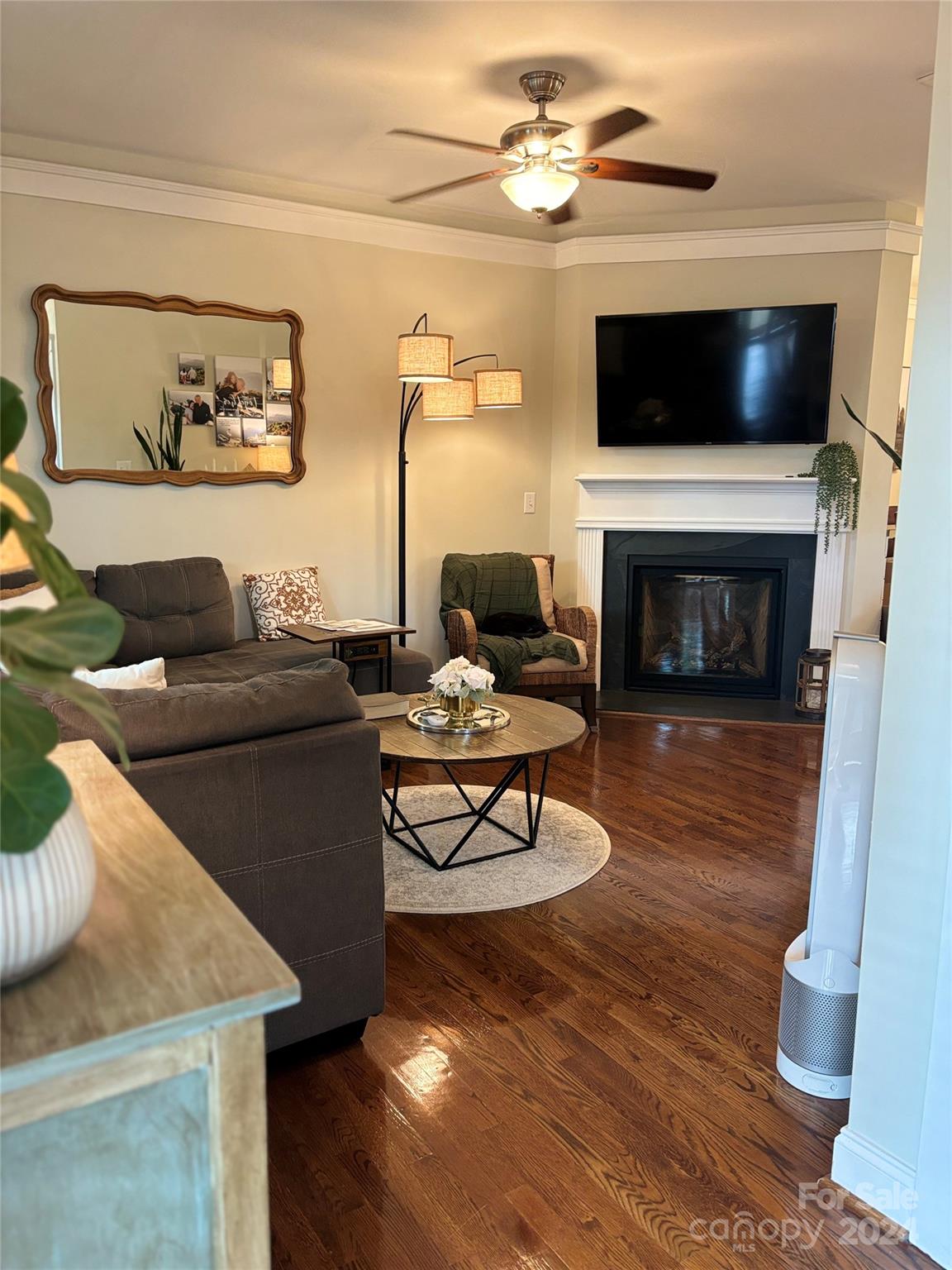 8303 Townley Road Huntersville, NC 28078 - Photo 5 of 22 a living room with furniture a fireplace and a flat screen tv