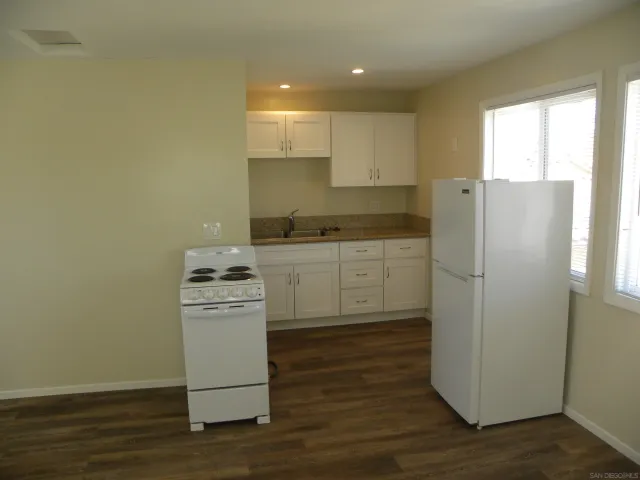 a kitchen with a sink stainless steel appliances and cabinets