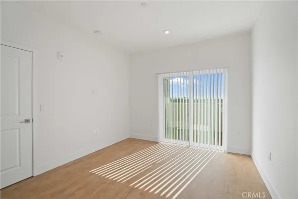 a view of a room with wooden floor and windows