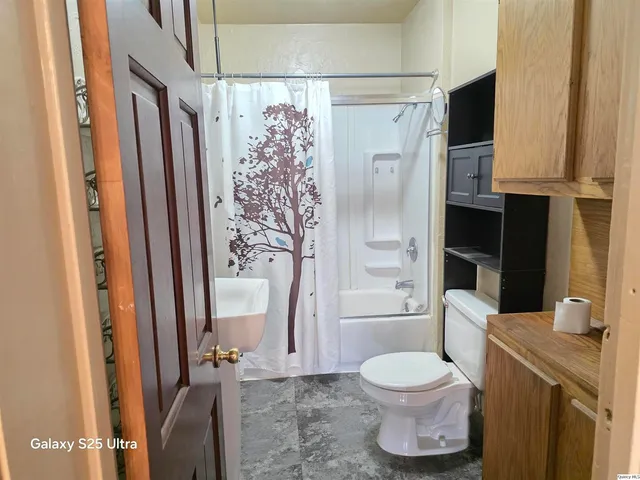 a bathroom with a toilet a sink and shower