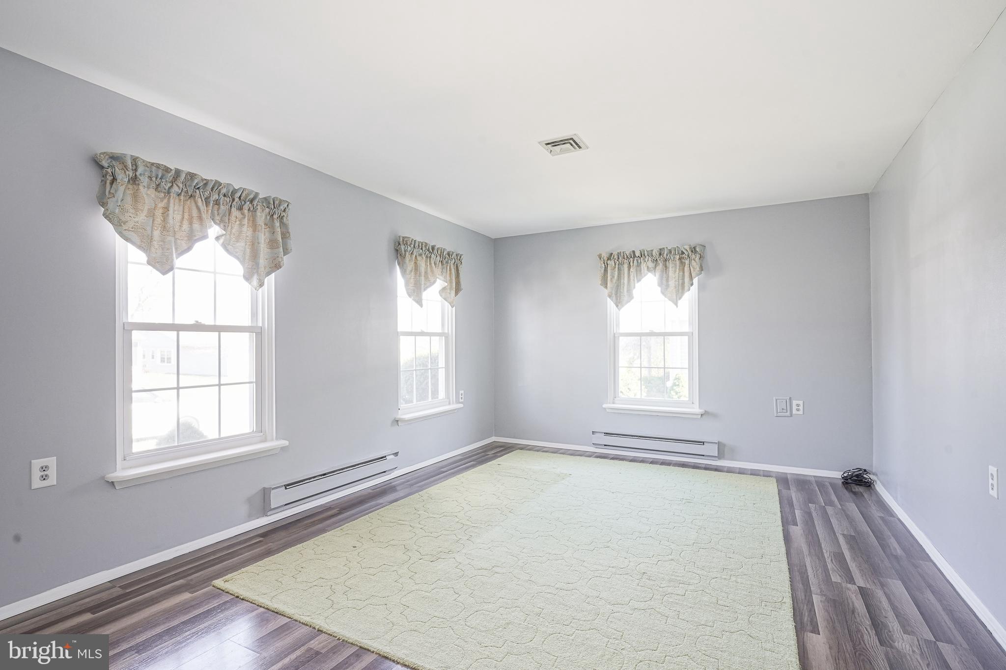 30 Buckingham Drive Southampton, NJ 08088 - Photo 5 of 24 an empty room with wooden floor and windows