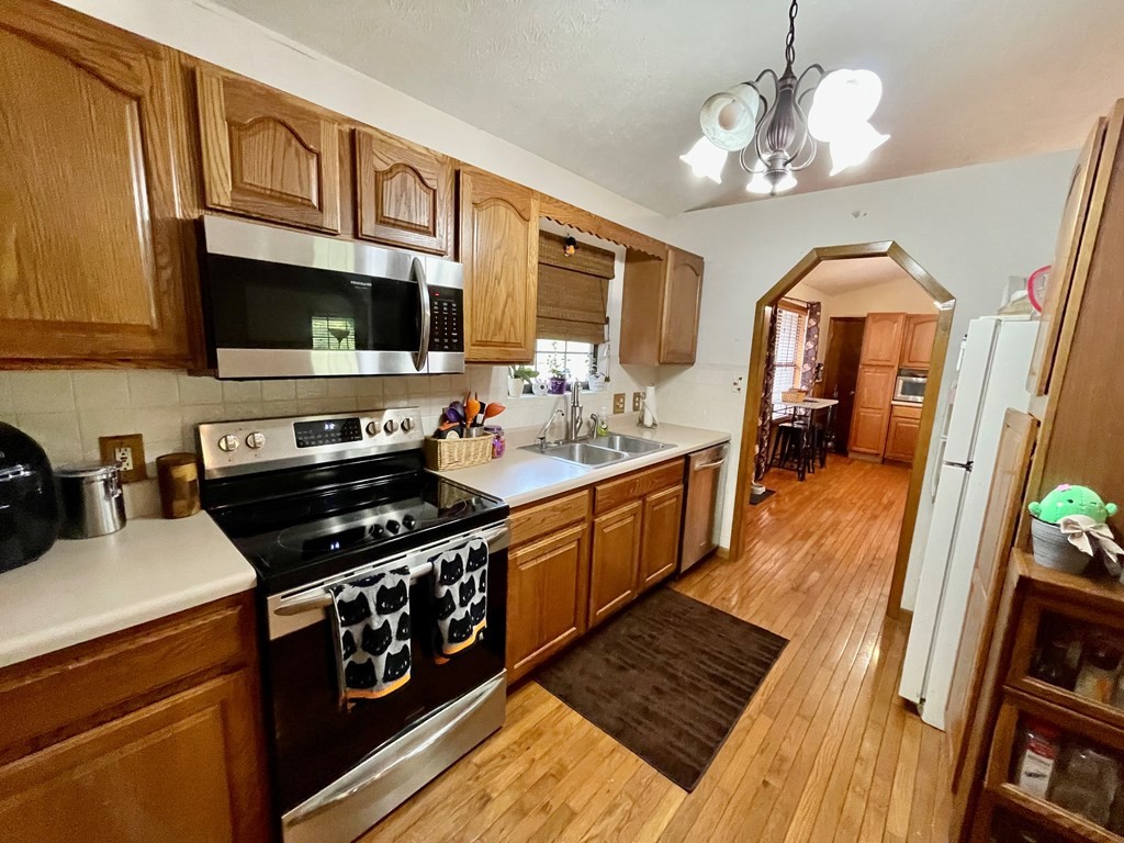 1050 Powder Springs Road Sevierville, TN 37876 - Photo 6 of 33 a kitchen with stainless steel appliances a stove sink microwave and cabinets