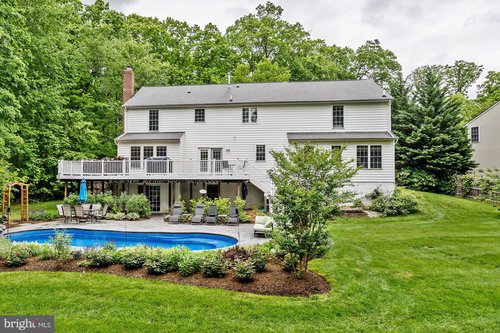 a front view of a house with a yard table and fountain