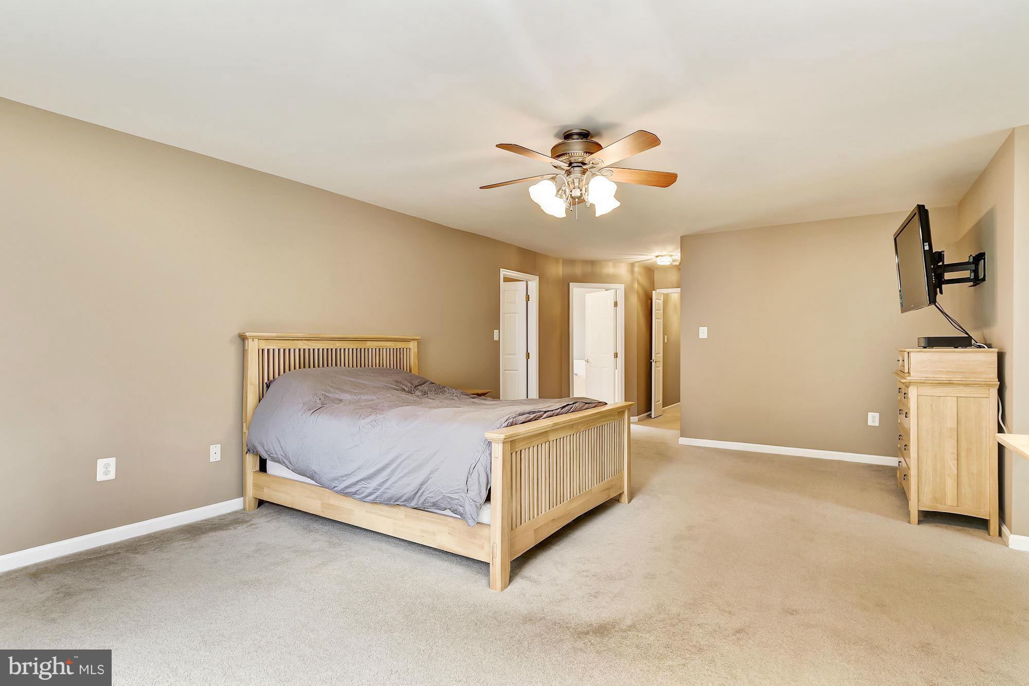 15530 Thompson Road Silver Spring, MD 20905 - Photo 16 of 30 a view of a bedroom with a ceiling fan and a chandelier fan