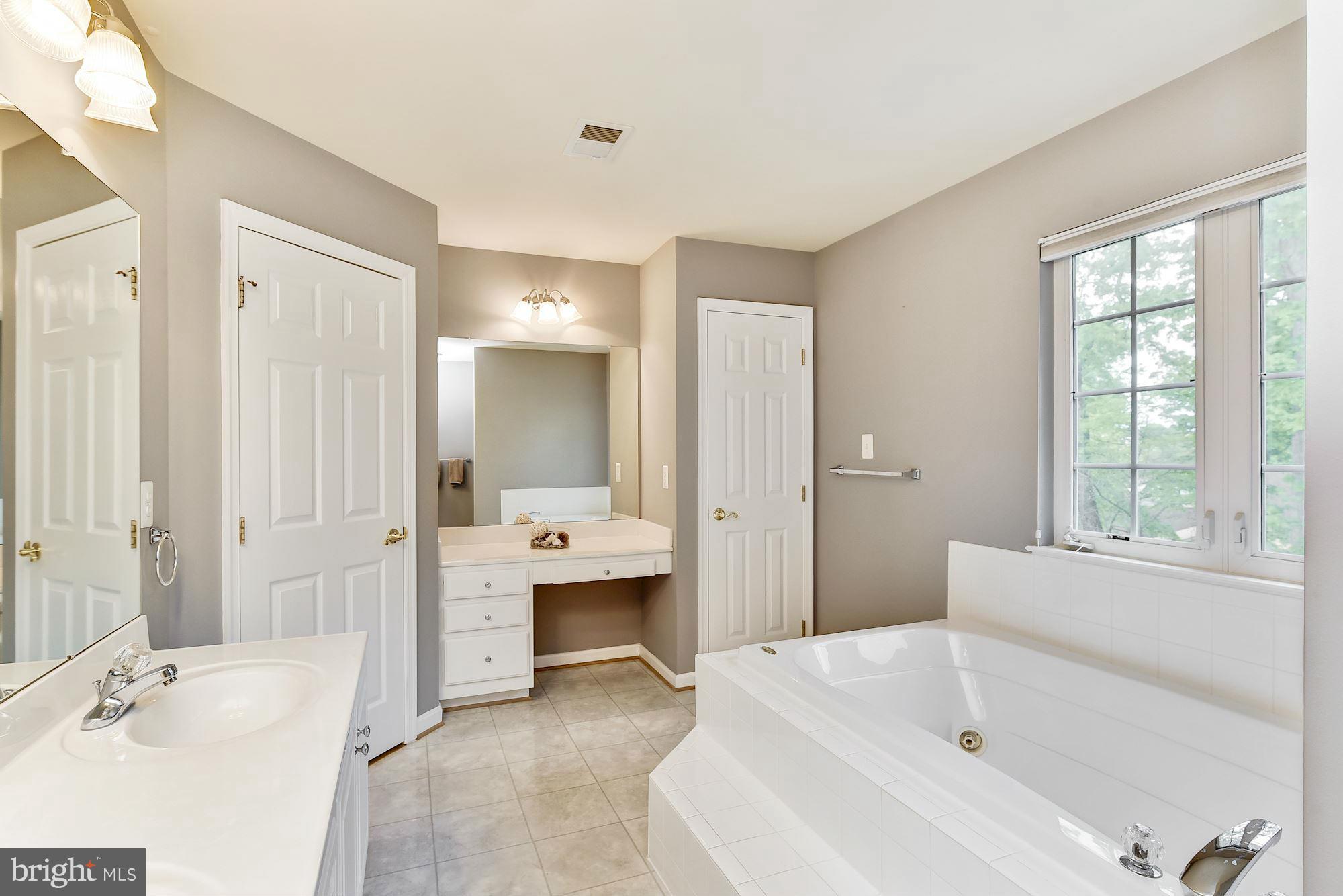 15530 Thompson Road Silver Spring, MD 20905 - Photo 17 of 30 a bathroom with a tub sink and mirror