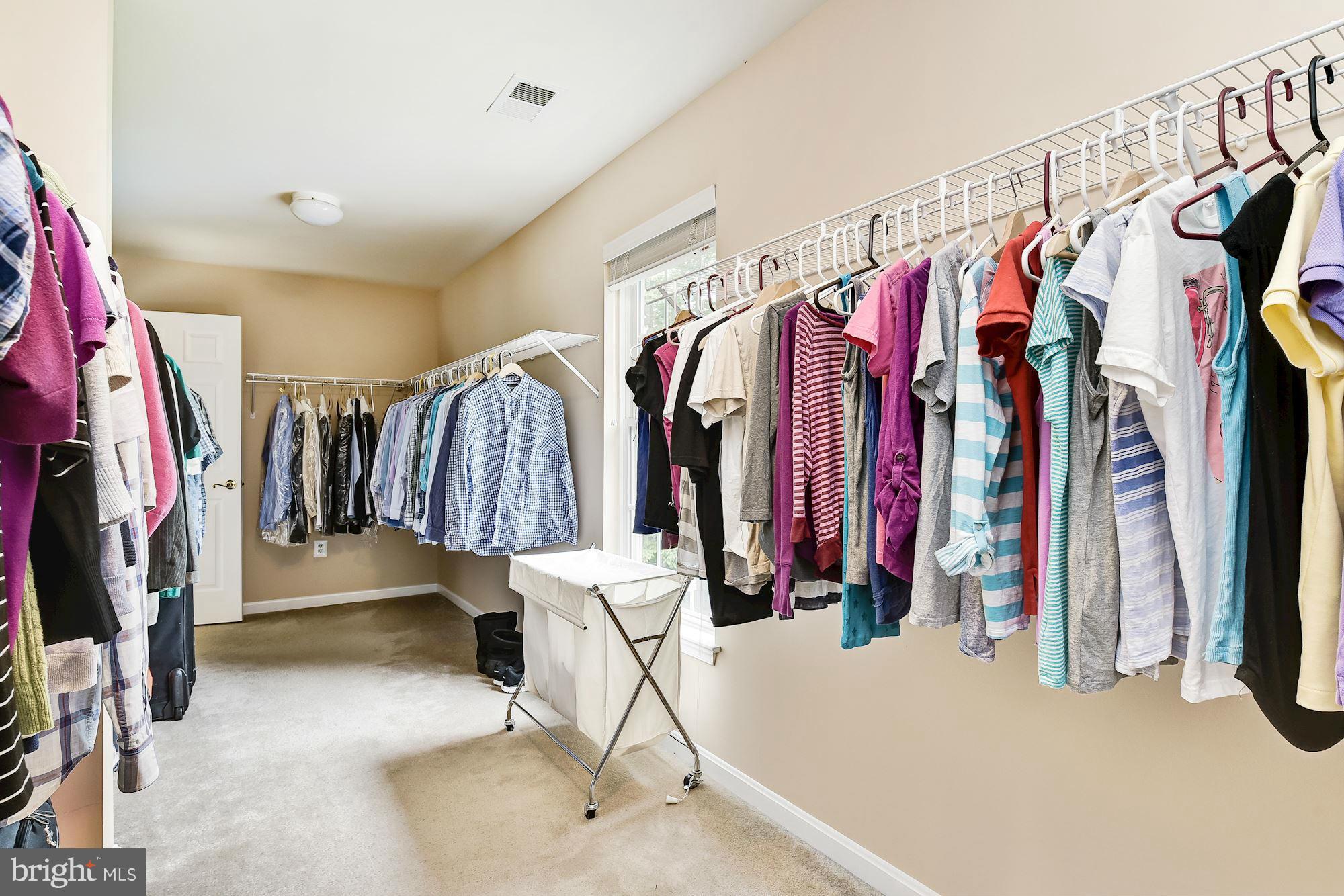 15530 Thompson Road Silver Spring, MD 20905 - Photo 18 of 30 a view of walk in closet with clothes