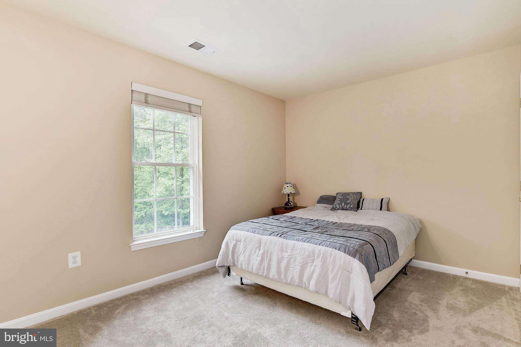 15530 Thompson Road Silver Spring, MD 20905 - Photo 20 of 30 a bedroom with a bed and a window