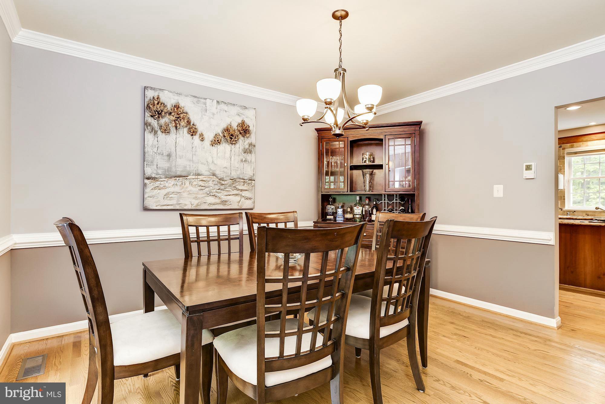 15530 Thompson Road Silver Spring, MD 20905 - Photo 7 of 30 a view of a dining room with furniture wooden floor and a chandelier