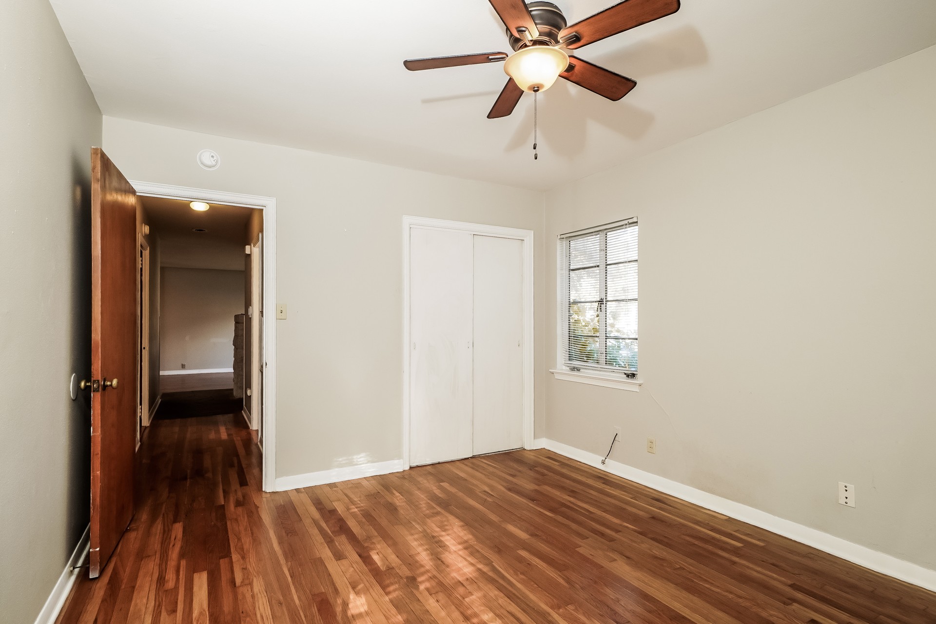2910 Hampton Road Austin, TX 78705 - Photo 15 of 27 Rich hardwood flooring flows through this bright, welcoming bedroom, complete with a functional ceiling fan and ample closet space.