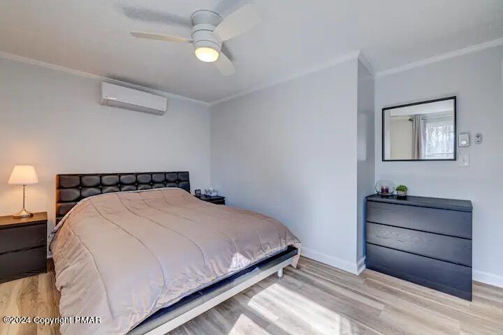 Sir Lionel Court Blakeslee, PA 18610 - Photo 11 of 23 a bedroom with a bed and a chandelier