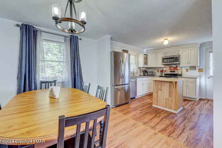 Sir Lionel Court Blakeslee, PA 18610 - Photo 5 of 23 a kitchen with granite countertop a refrigerator a stove a sink a dining table and chairs