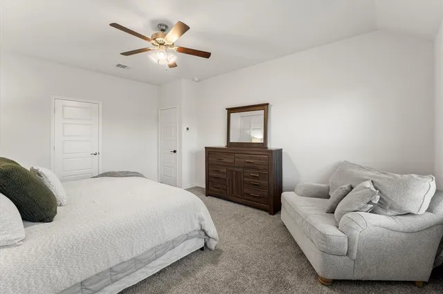 a bedroom with a bed and ceiling fan