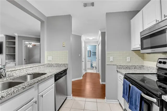a kitchen with granite countertop a sink and a stove