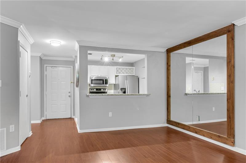 3655 Habersham Road Northeast, Unit 244B Atlanta, GA 30305 - Photo 13 of 34 a view of kitchen and hall with wooden floor