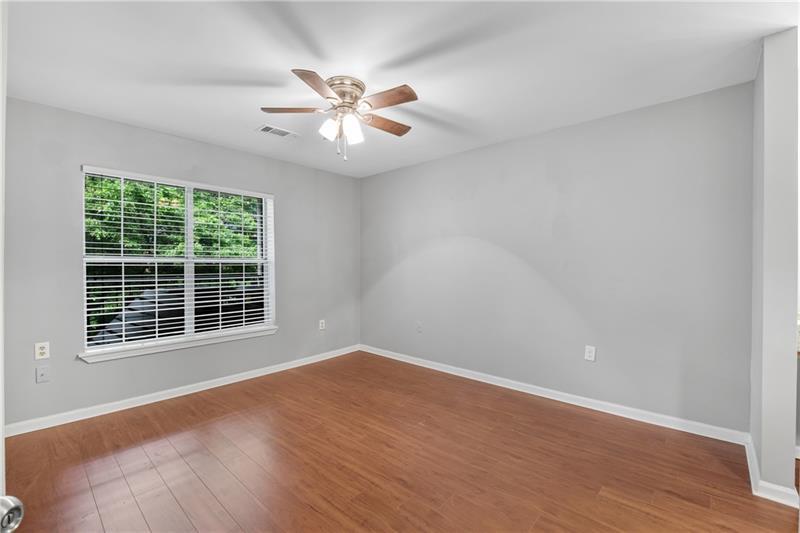 3655 Habersham Road Northeast, Unit 244B Atlanta, GA 30305 - Photo 14 of 34 a view of an empty room with wooden floor and a window