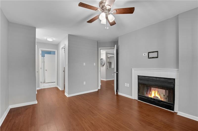 3655 Habersham Road Northeast, Unit 244B Atlanta, GA 30305 - Photo 15 of 34 a view of an empty room with wooden floor fireplace and a window