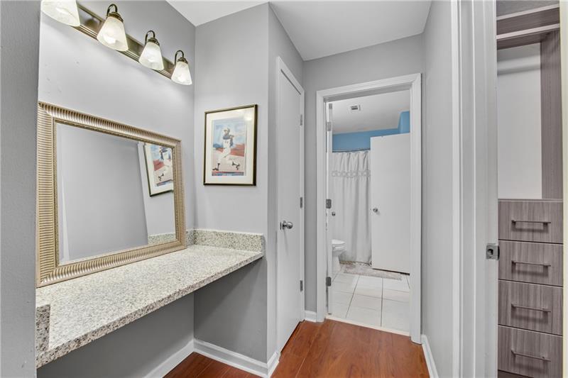 3655 Habersham Road Northeast, Unit 244B Atlanta, GA 30305 - Photo 16 of 34 a en suite bathroom with a granite countertop sink mirror and vanity