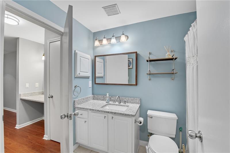 3655 Habersham Road Northeast, Unit 244B Atlanta, GA 30305 - Photo 20 of 34 a bathroom with a toilet sink and mirror
