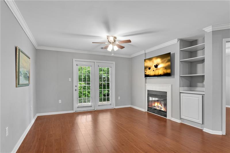 3655 Habersham Road Northeast, Unit 244B Atlanta, GA 30305 - Photo 2 of 34 a view of an empty room with a fireplace and a window