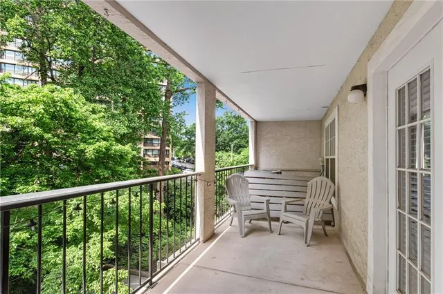 a view of a two chairs in the balcony