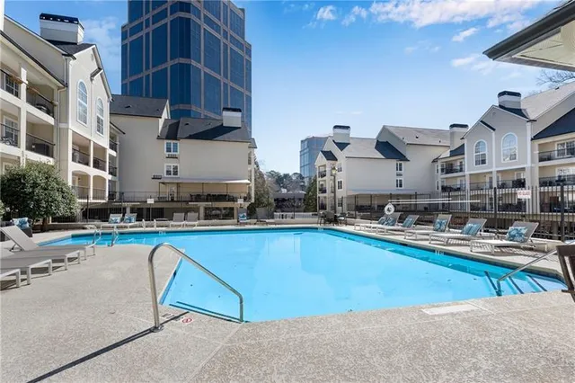 a swimming pool with outdoor seating and yard