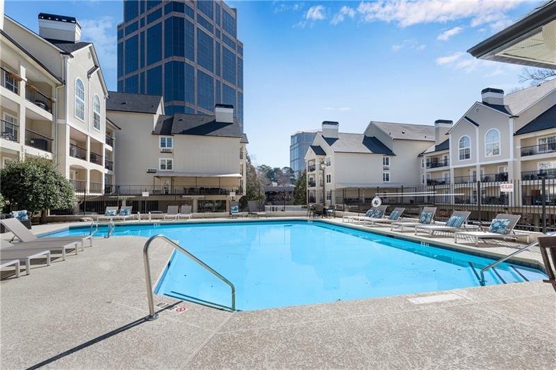 3655 Habersham Road Northeast, Unit 244B Atlanta, GA 30305 - Photo 27 of 34 a swimming pool with outdoor seating and yard
