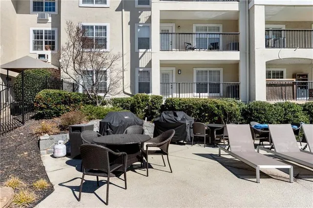 a view of a patio with table and chairs and potted plants