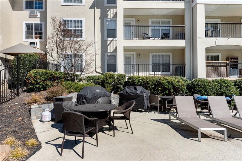 3655 Habersham Road Northeast, Unit 244B Atlanta, GA 30305 - Photo 29 of 34 a view of a patio with table and chairs and potted plants