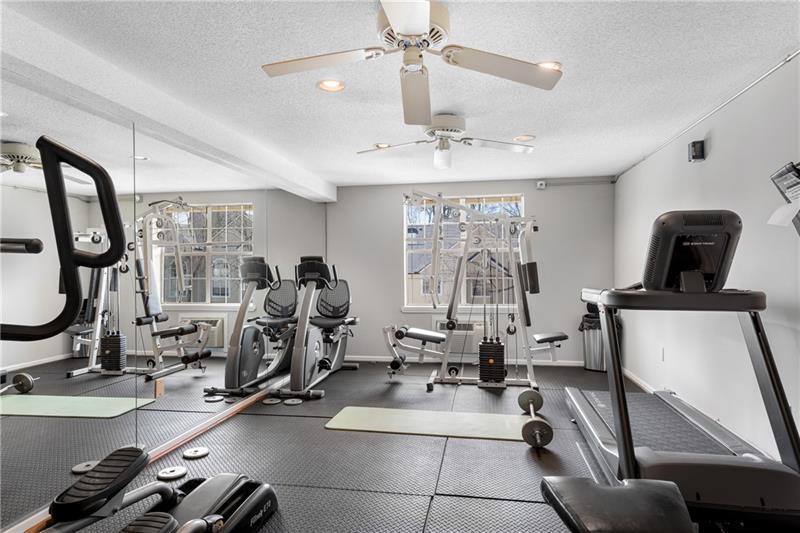 3655 Habersham Road Northeast, Unit 244B Atlanta, GA 30305 - Photo 31 of 34 a room with gym equipment and large windows
