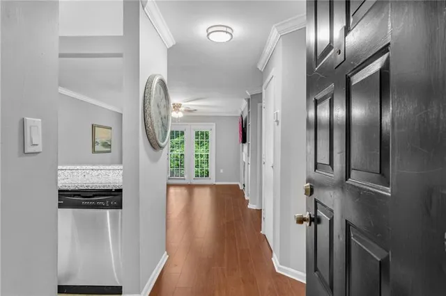 a view of a hallway with wooden floor