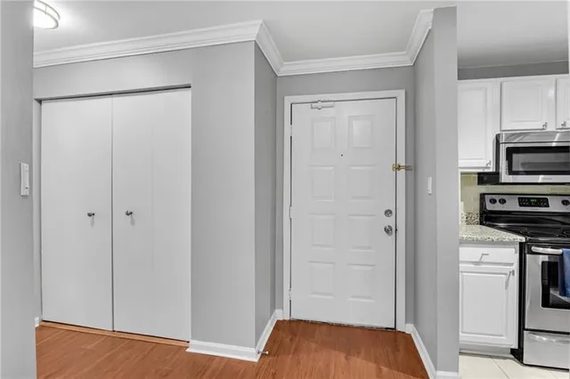 a view of bedroom with a bed and cabinets