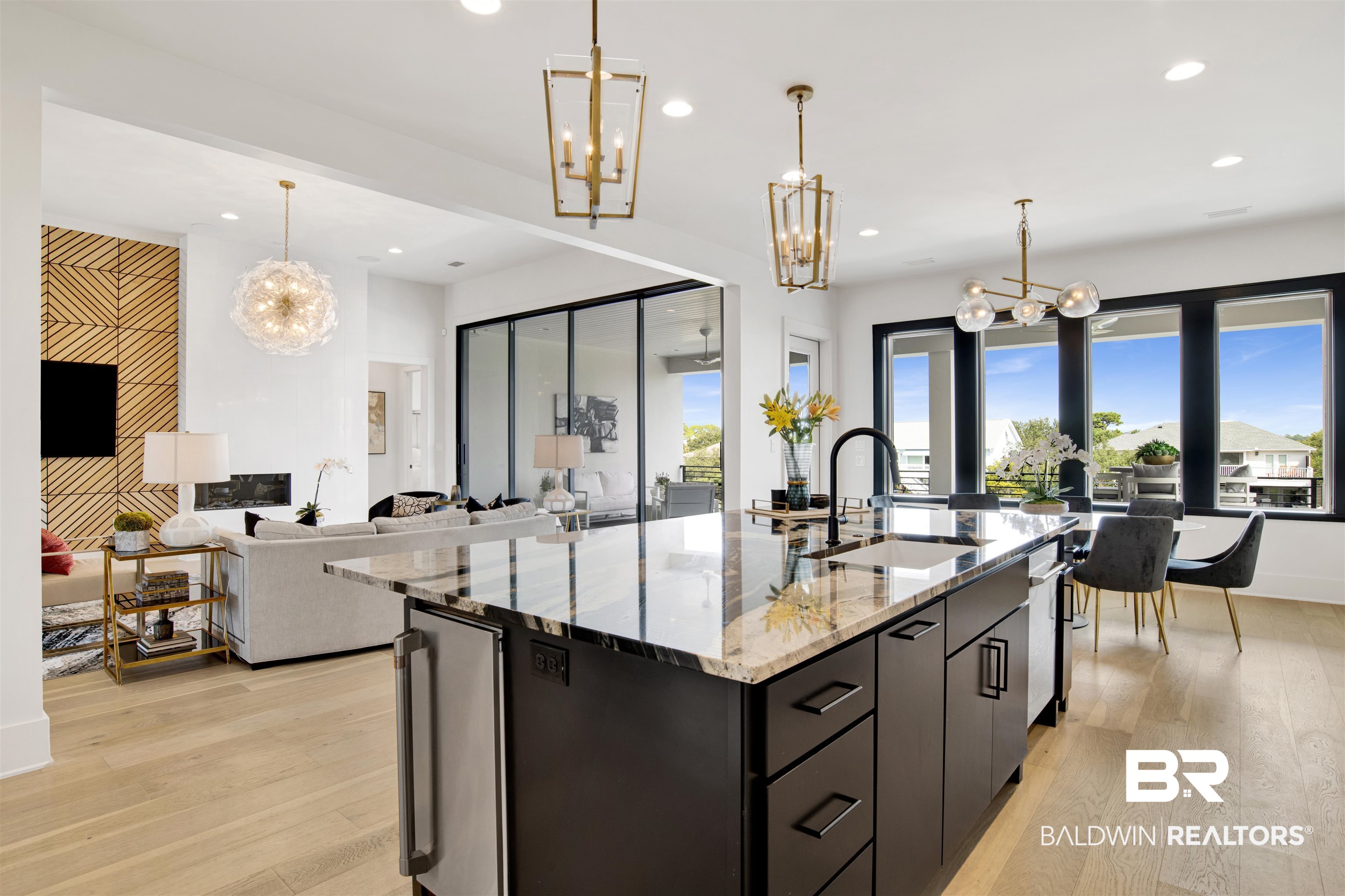 30239 Canal Court Orange Beach, AL 36561 - Photo 23 of 70 Kitchen featuring a chandelier, decorative light fixtures, light stone counters, an island with sink, and recessed lighting