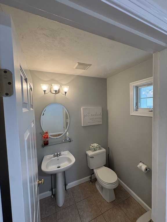 45 Crescent Road, Unit 45 Needham, MA 02494 - Photo 22 of 25 a bathroom with a toilet a sink and mirror