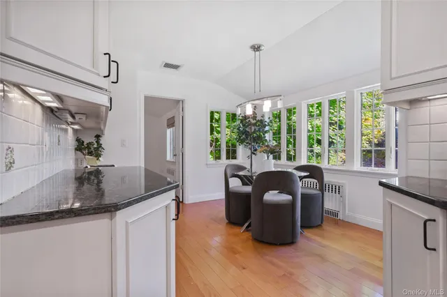 a kitchen with granite countertop a sink a counter top space and living room area