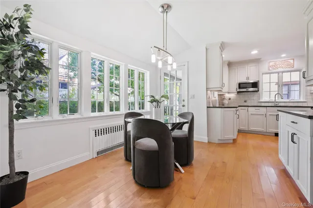 a kitchen with kitchen island granite countertop a sink and a stove top oven
