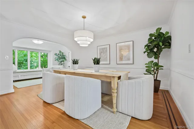 a living room with a sink and dishwasher with wooden floor