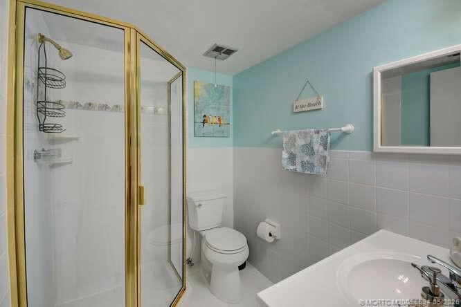 1950 Southwest Palm City Road, Unit 3209 Stuart, FL 34994 - Photo 19 of 64 Guest bathroom with walk in shower.