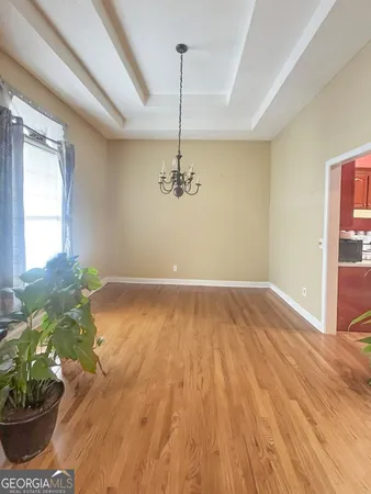 a view of a room with wooden floor