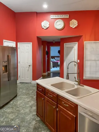 a kitchen with stainless steel appliances granite countertop a sink and a refrigerator