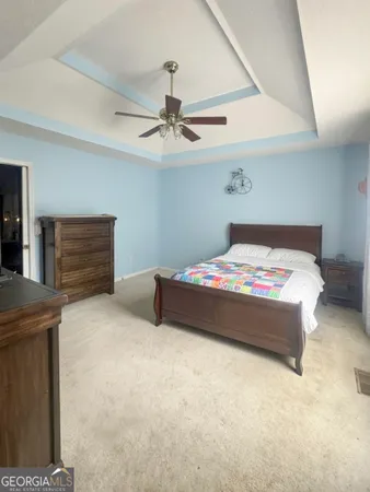 a bedroom with a bed and a ceiling fan
