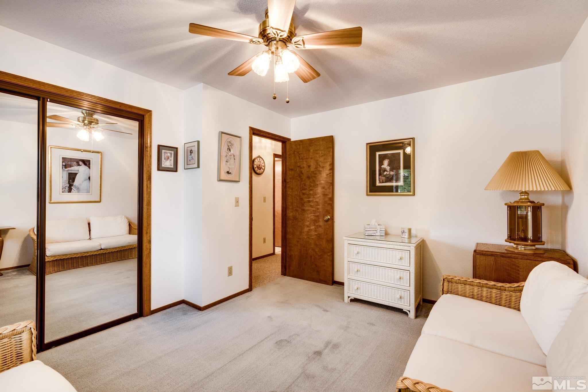 1850 Karin Drive Carson City, NV 89706 - Photo 17 of 40 a view of a livingroom with furniture cabinet and a ceiling fan