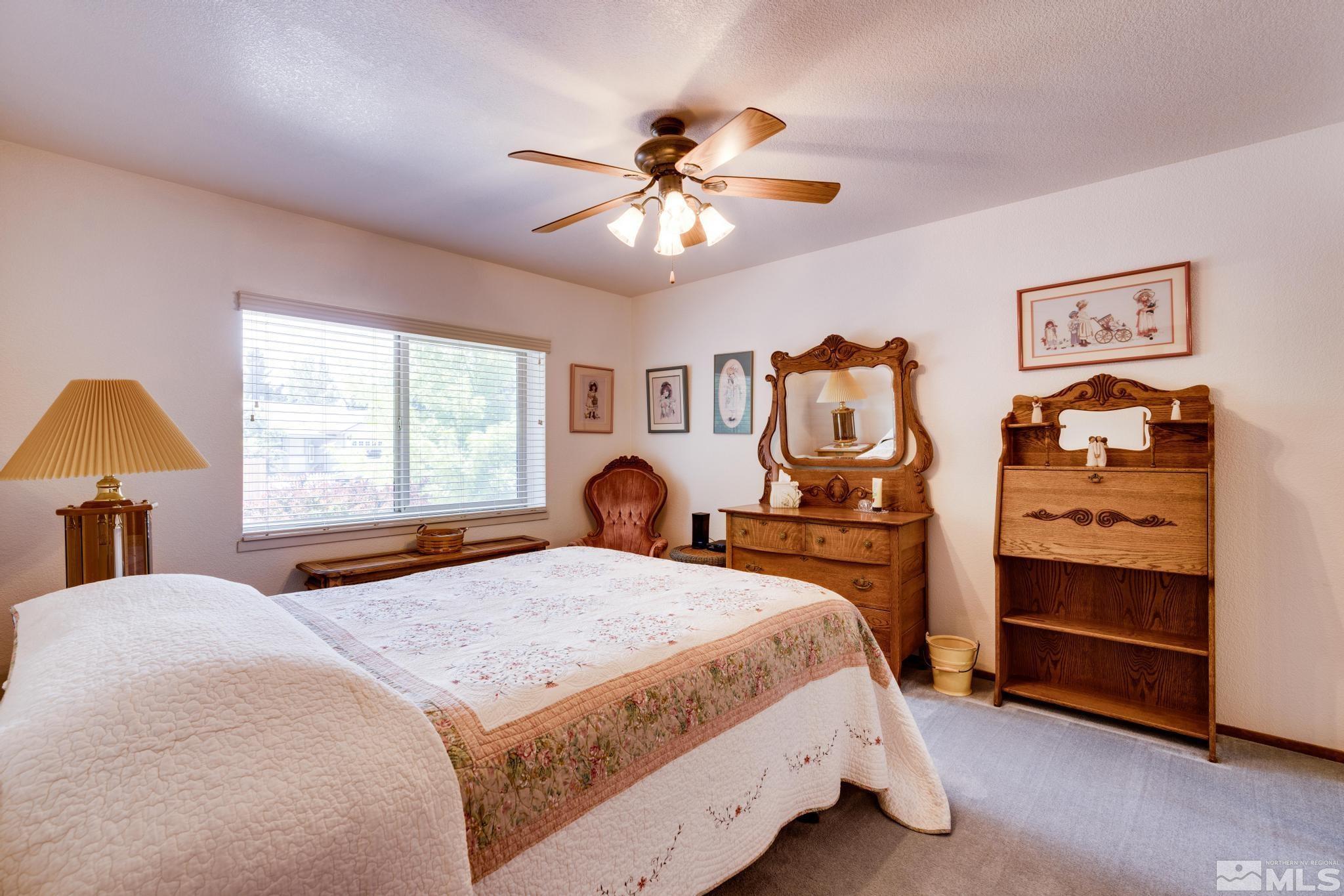 1850 Karin Drive Carson City, NV 89706 - Photo 19 of 40 a bedroom with a bed and a chandelier