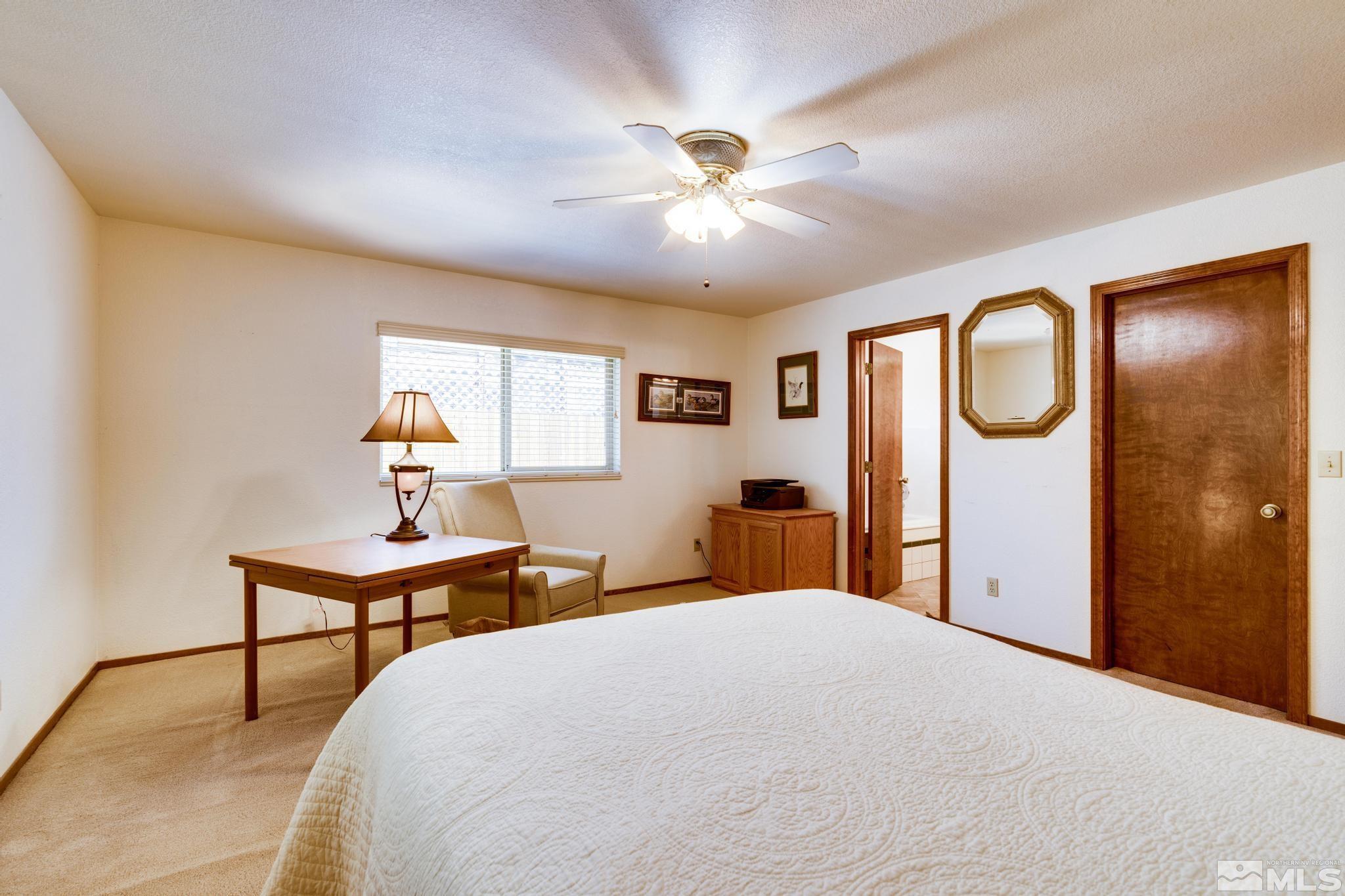 1850 Karin Drive Carson City, NV 89706 - Photo 25 of 40 a bedroom with a bed and a chandelier