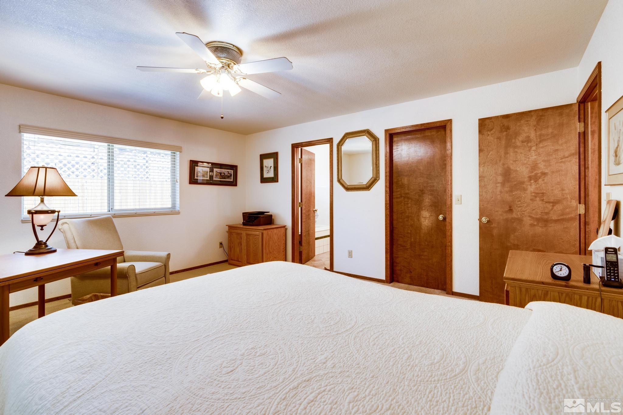 1850 Karin Drive Carson City, NV 89706 - Photo 26 of 40 a bedroom with a bed and a chandelier