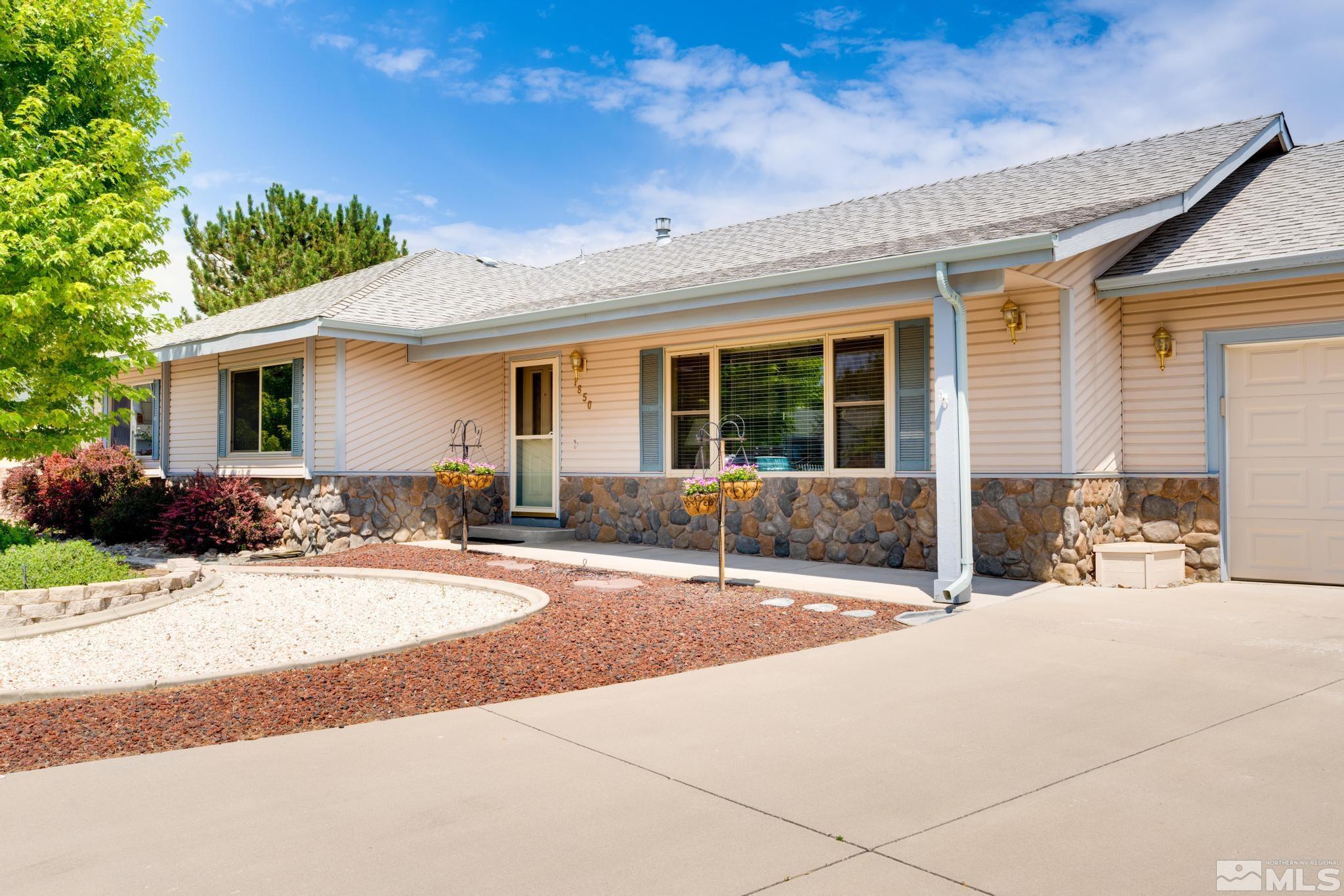 1850 Karin Drive Carson City, NV 89706 - Photo 40 of 40 a front view of a house with yard outdoor seating and garage