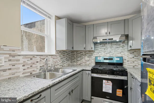 a view of a hallway with wooden floor and entryway
