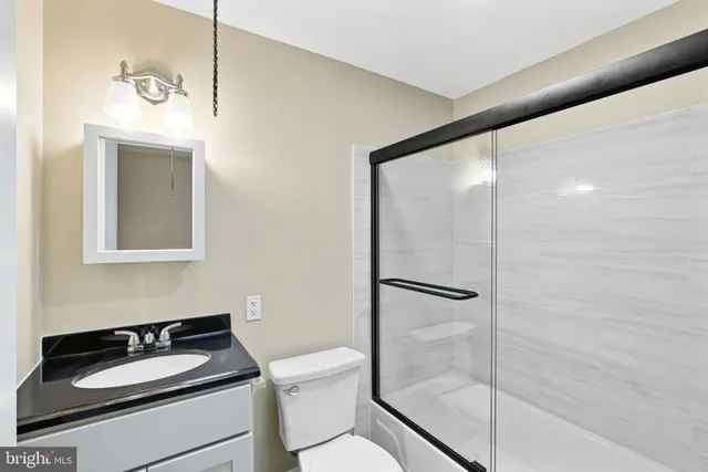 an empty room with wooden floor and closet