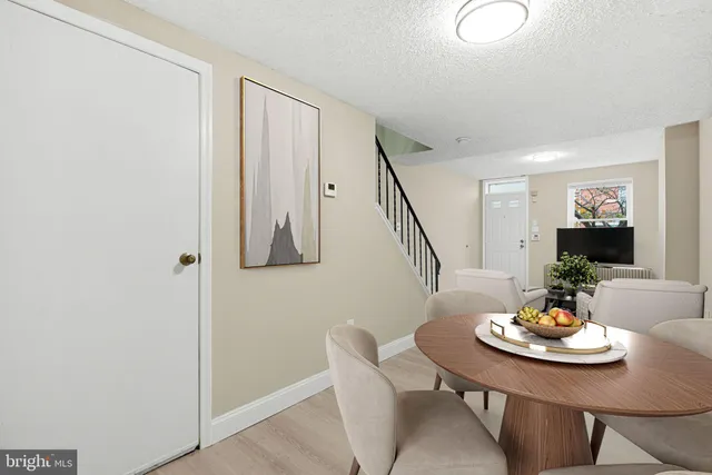 a view of hallway with stairs and wooden floor