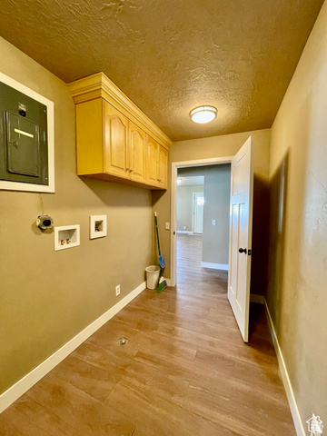 255 West Main Street Mount Pleasant, UT 84647 - Photo 20 of 35 Dedicated utility area featuring wood-finish flooring, built-in cabinetry, overhead lighting, and white baseboards