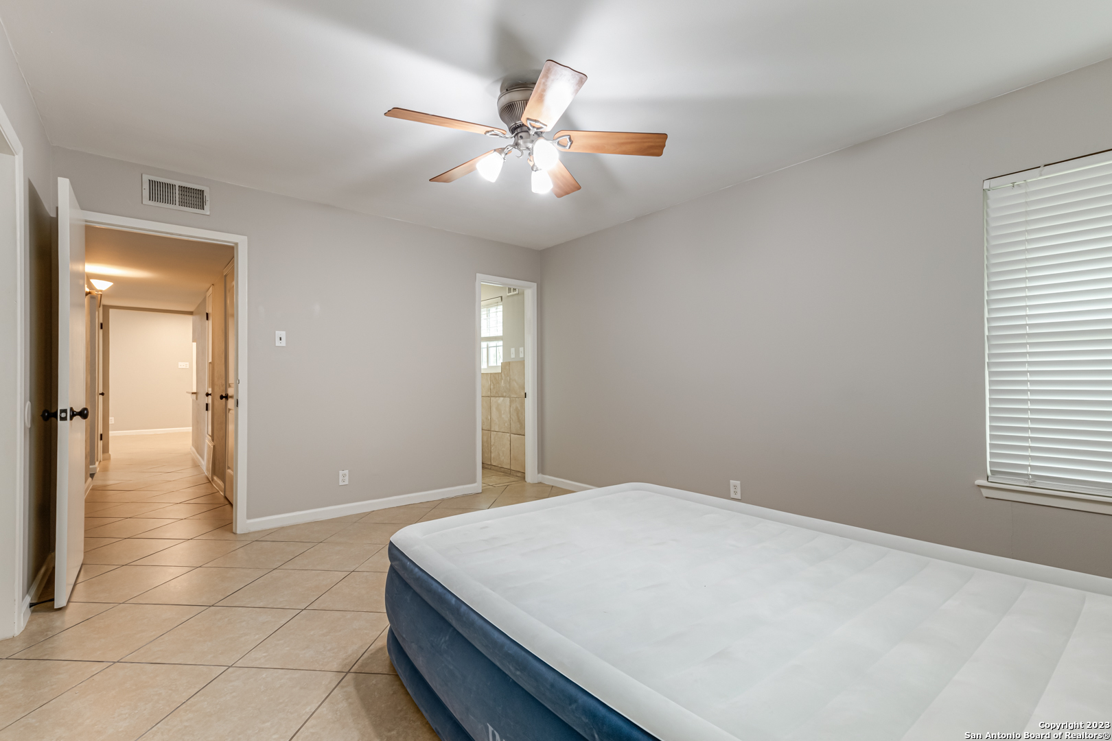 555 Patricia San Antonio, TX 78216 - Photo 15 of 33 a bedroom with a bed and a window